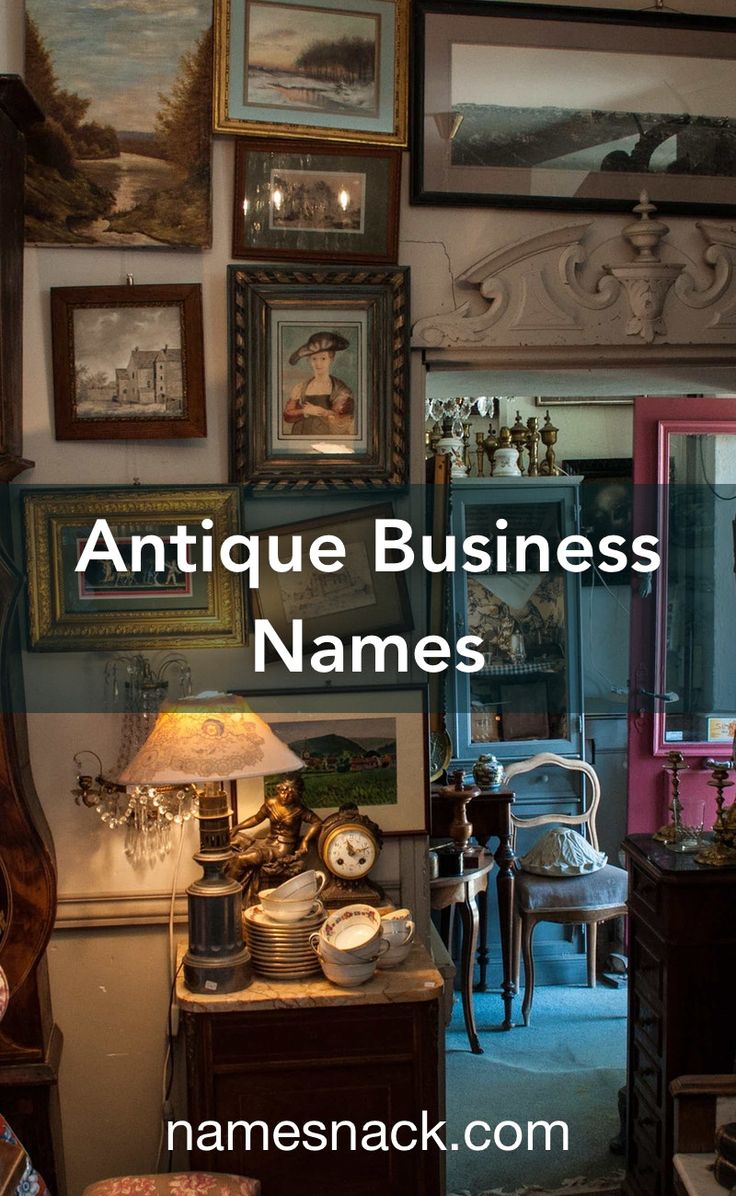 antique business names are displayed in front of pictures on the wall and below them is a lamp