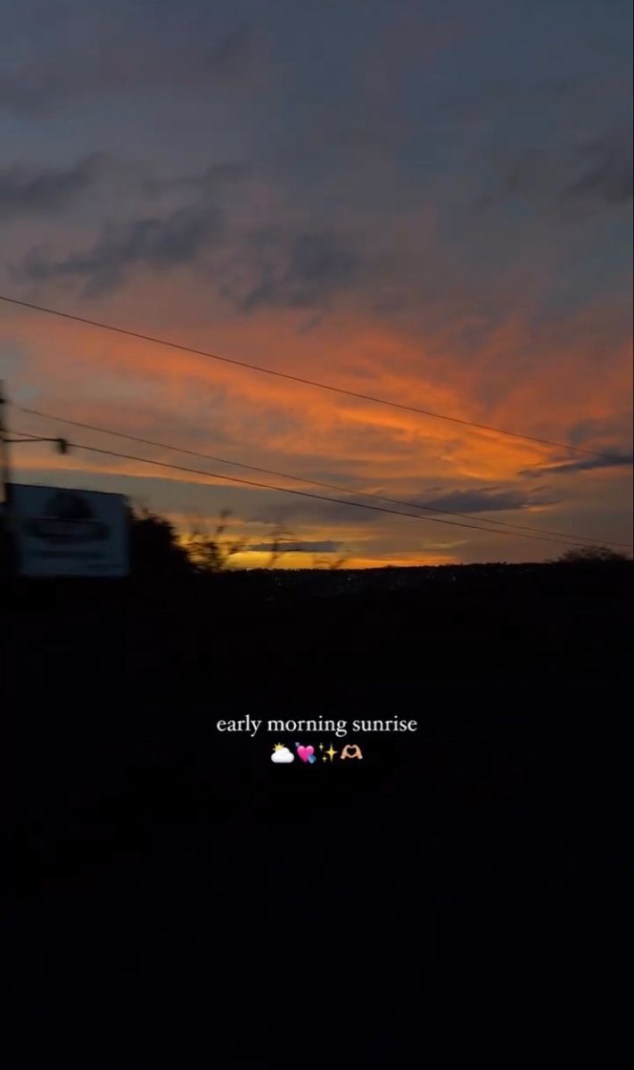 the sun is setting behind some power lines and telephone poles with an advertisement that reads, early morning sunrise