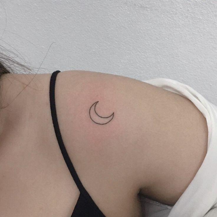 a woman with a crescent tattoo on her shoulder