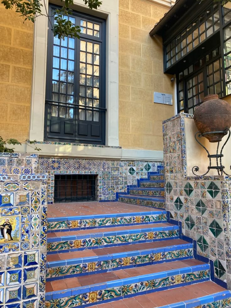 blue and white tiled steps leading up to a window