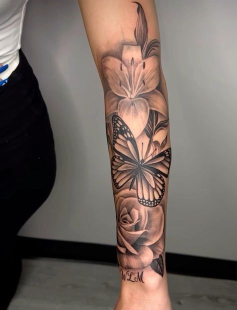 a woman's leg with a butterfly and flower tattoo on the left side of her arm