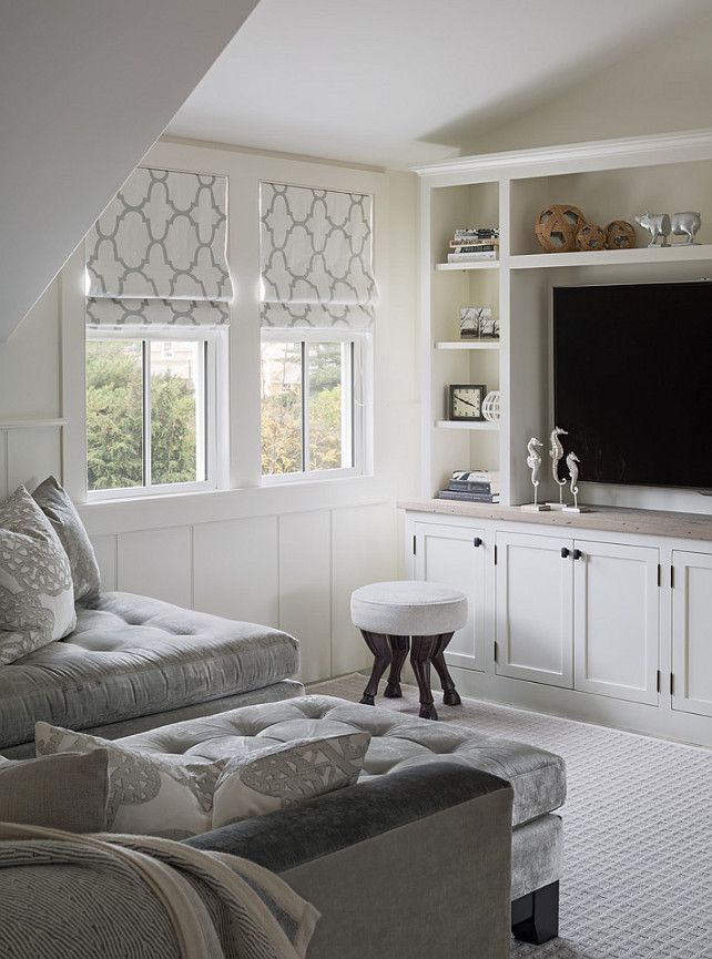 a living room filled with furniture and a flat screen tv on top of a wall