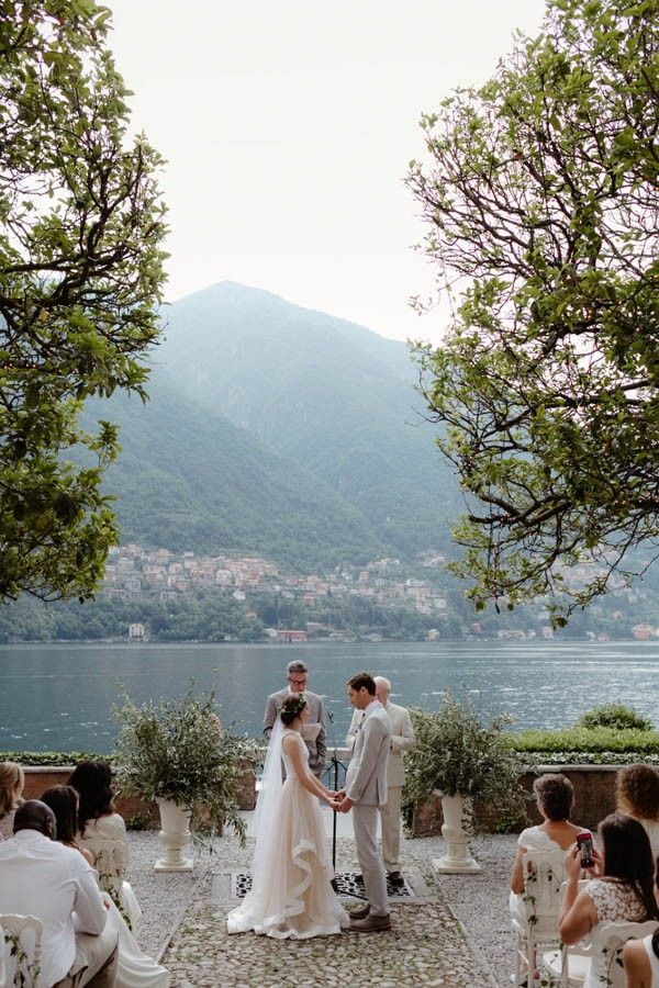 a couple getting married in front of the lake