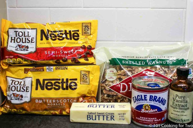 some food is sitting on the counter in front of a white tile wall and two bags of nuts