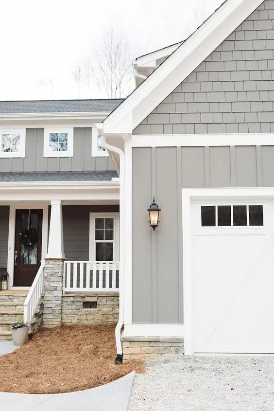 a gray and white house with two garages