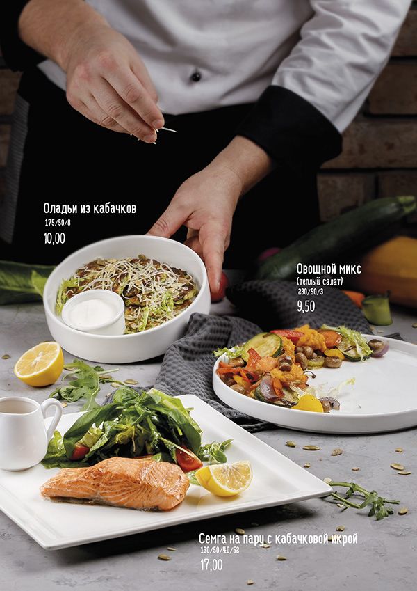 a person is preparing food on a table with other dishes and utensils in front of them