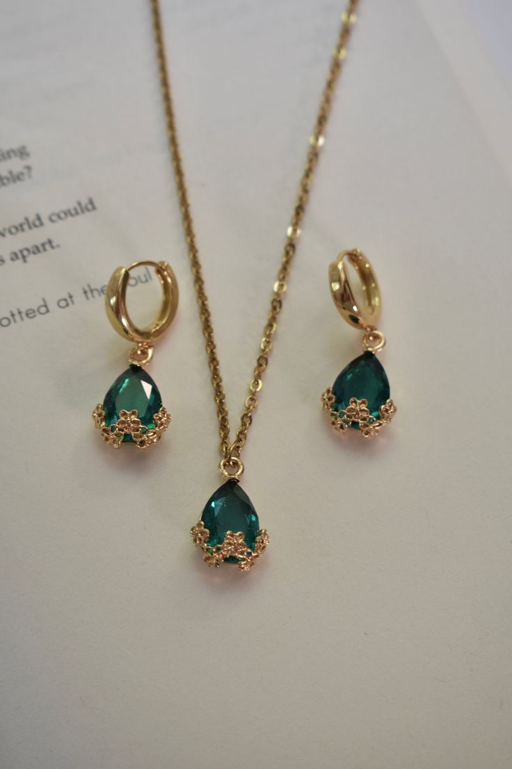 Our Emerald Night Set includes a pair of earrings and a matching necklace. This set can also be sold separately. Color - Green & Gold Material - Stainless Steel & Zinc Alloy measurements - Hoop: 0.5 inches, Earring Drop: 1.20 inches, Necklace Length: 20.5 inches. Green Gifts Aesthetic, Emerald Jewellery Set, Emerald Jewelry Gold, Emerald And Gold Necklace, Emerald Sets Jewellery, Deep Winter Jewelry, Gold Emerald Jewelry, Emerald Jewelry Aesthetic, Gold And Emerald Jewelry