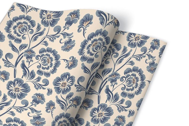 two blue and white wallpapers with floral designs on them, one is folded up to the side