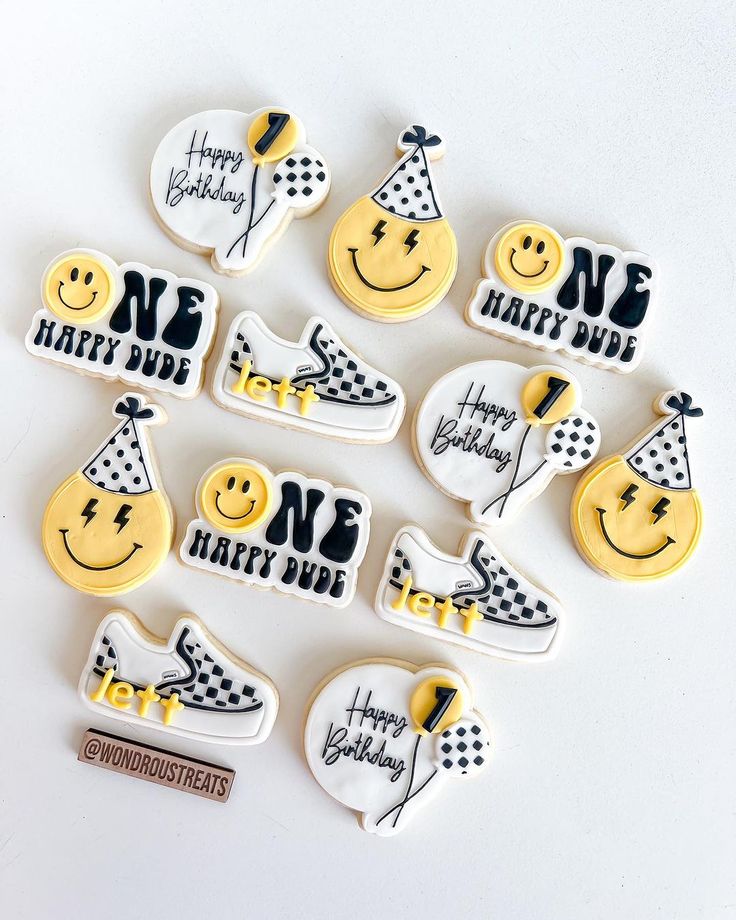 happy birthday decorated cookies arranged in the shape of shoes and smiley faces with hats on them