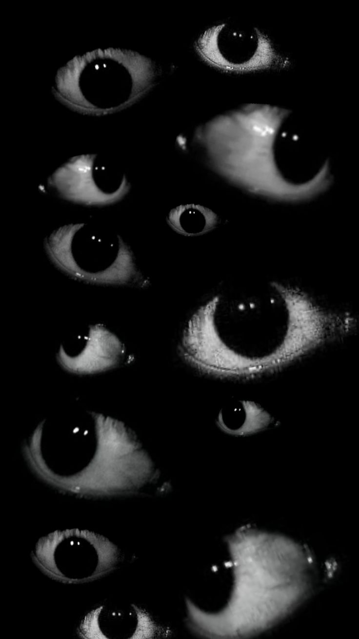 an image of many eyes in the dark