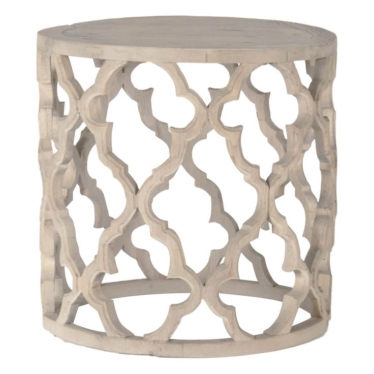 a white wooden table with an intricate design on the top and bottom, against a white background