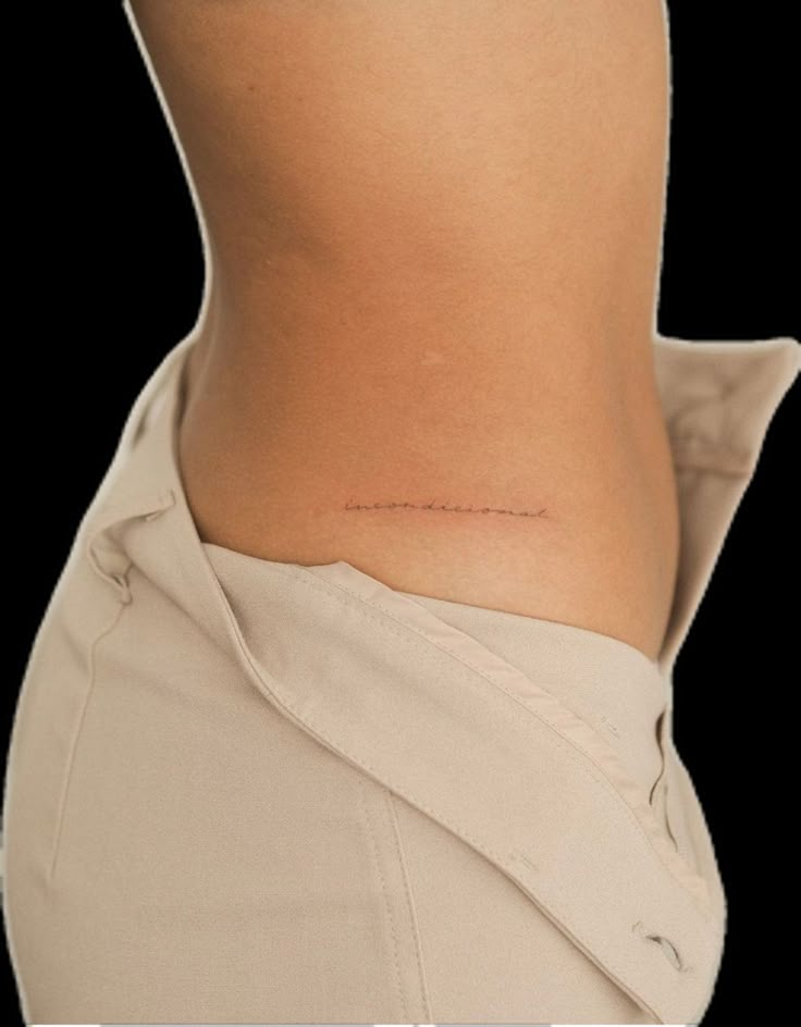 a woman's lower back with the word love written on it