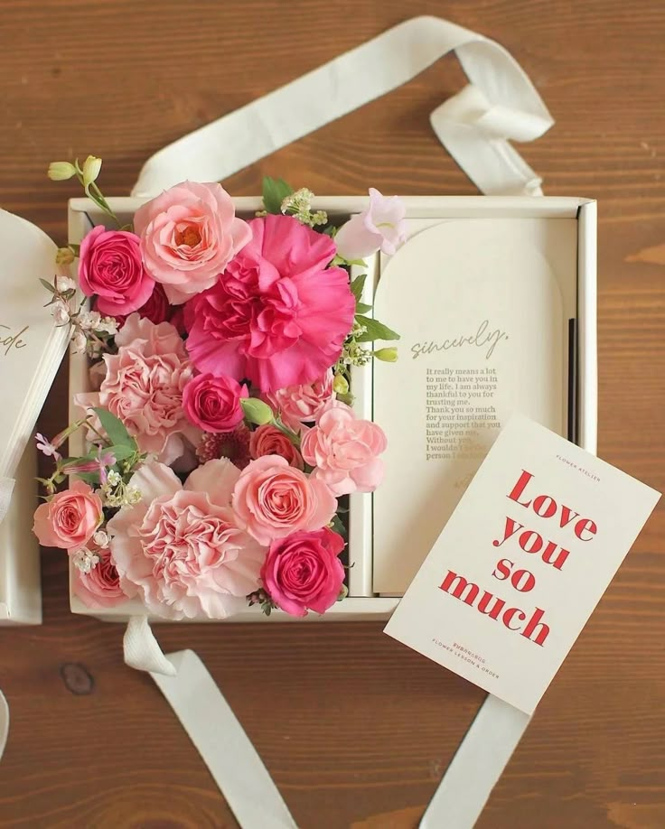 a box with pink flowers and a book