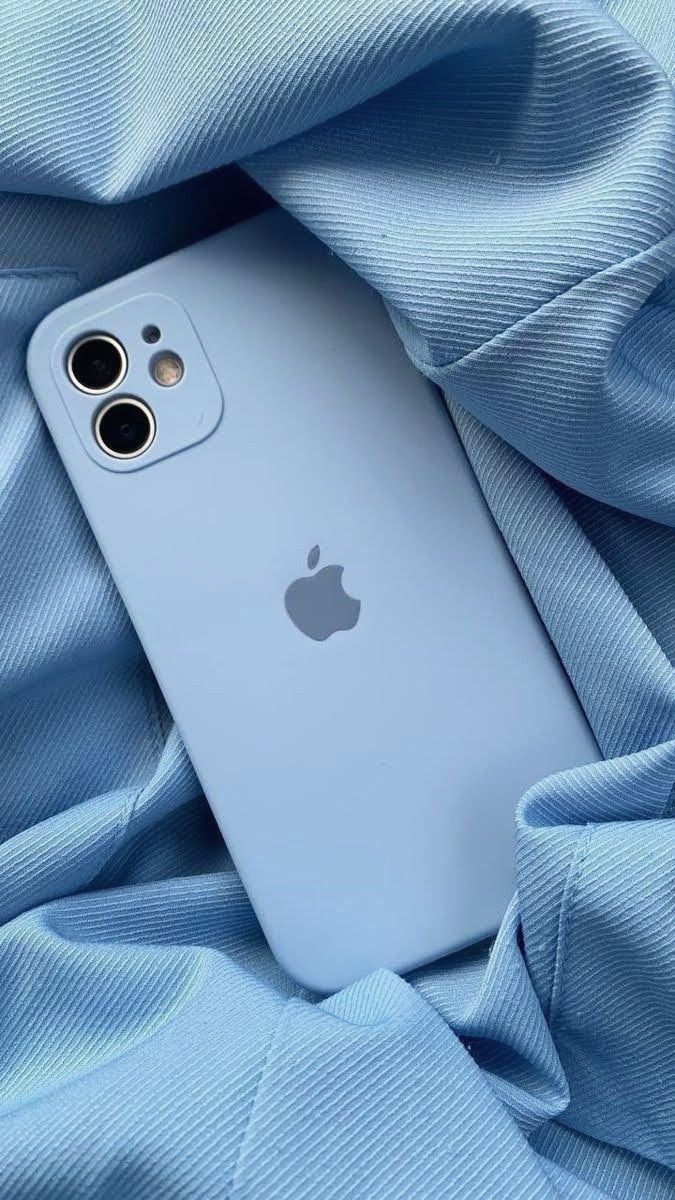 an iphone is laying on top of a blue blanket with the camera lens facing up