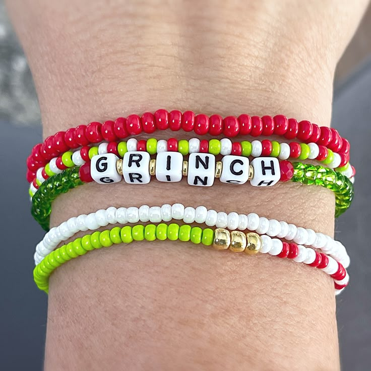 Show a little Christmas spirit with this fun Grinch inspired bracelet set. Perfect for gift giving for those that love the holidays! Secret Santa gift, holiday housewarming or something to enjoy for yourself.  You will receive 5 bracelets in this set. Each piece is handmade with: - High Quality Glass Seed Beads - White/Black Acrylic Cube Letter Beads - Stretch Cord: High-quality cord with reinforced knots Easily layer with other Luna by Rachel bracelets for a stunning stack! My pieces are made sturdy, but as with all jewelry, they are also delicate and should be treated with care. Be sure to check out other designs in my shop at http://etsy.com/shop/lunabyrachel  Thank you for shopping Luna by Rachel ~ Unique Jewelry for Unique Individuals Novelty Colorful Beaded Bracelets As Gifts, Holiday Jewelry With Letter Beads, Holiday Jewelry With Letter Round Beads, Holiday Jewelry With Round Letter Beads, Christmas Gift Beaded Bracelets With Letter Beads, Christmas Gift Beaded Bracelet With Letter Beads, Personalized Adjustable Beaded Bracelets For Christmas, Personalized Beaded Bracelets For Christmas Gift, Green Beaded Bracelets For Holiday Gifts