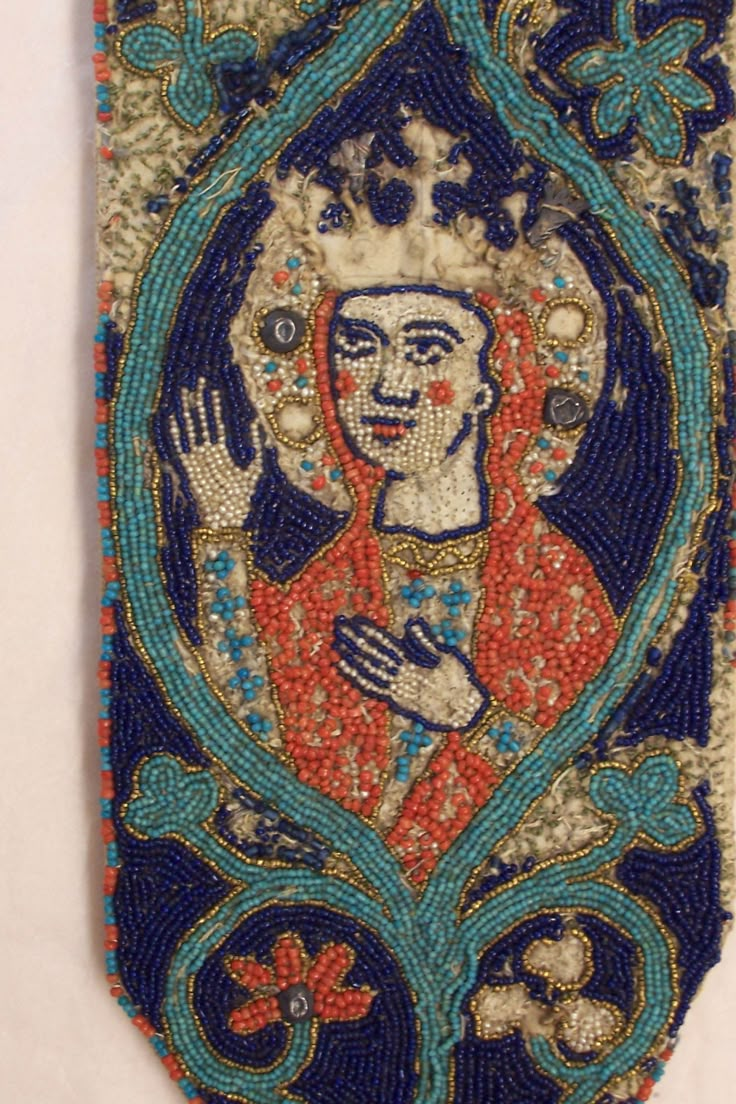 an old beaded cloth with a painting on it