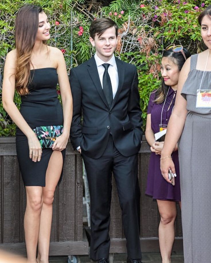 three people in formal wear standing next to each other