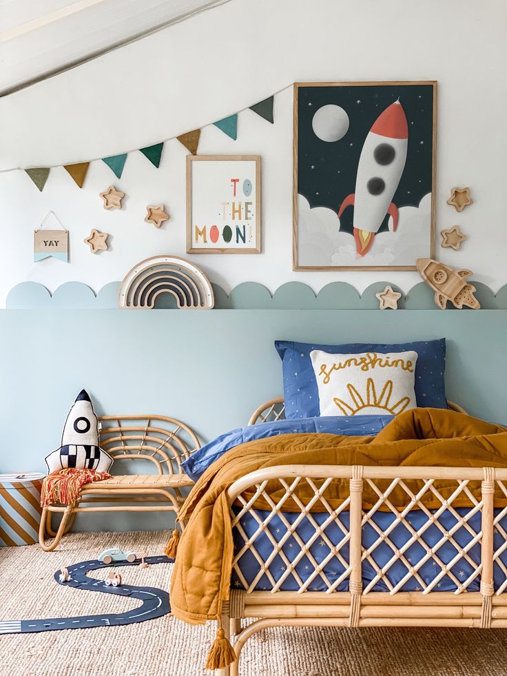 a bedroom with blue walls and pictures on the wall, including a rocket ship bed