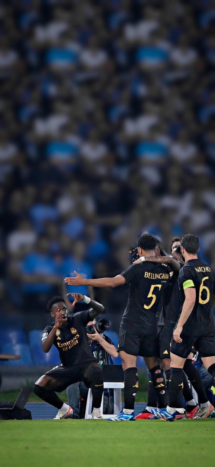 a group of men standing on top of a soccer field