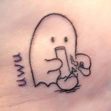 a tattoo on the side of a woman's stomach with a drawing of a ghost