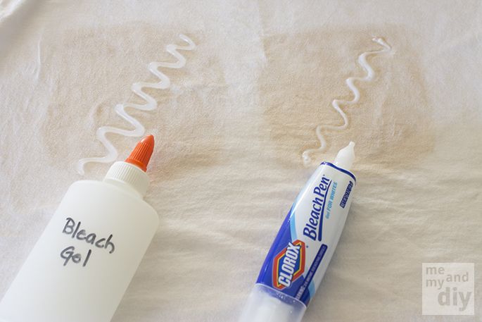 an orange and white toothbrush sitting next to a tube of toothpaste on a bed