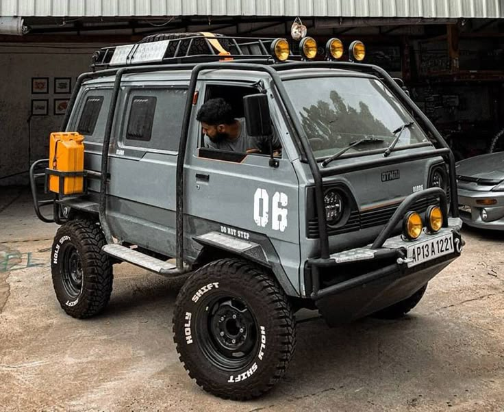 a man sitting in the driver's seat of an off road vehicle