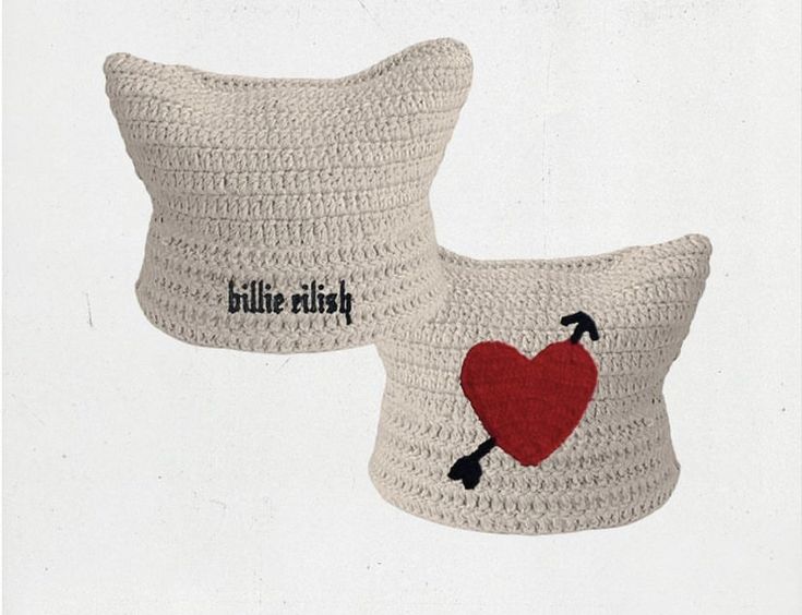 two crocheted pillows with red heart on them