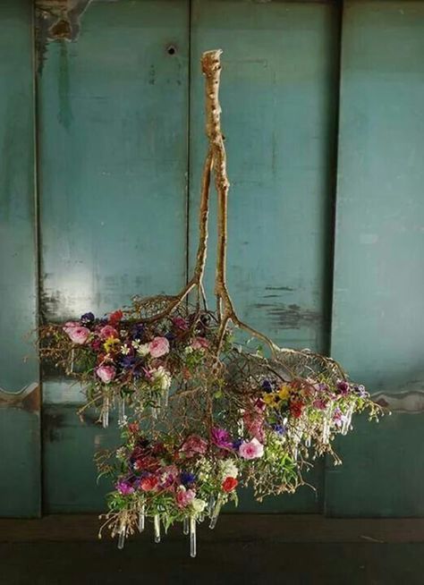 an arrangement of flowers hanging from the ceiling