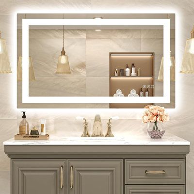 a bathroom vanity with a large mirror above it and lights hanging from the ceiling over it