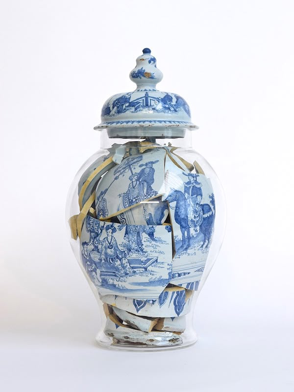 a blue and white vase sitting on top of a table