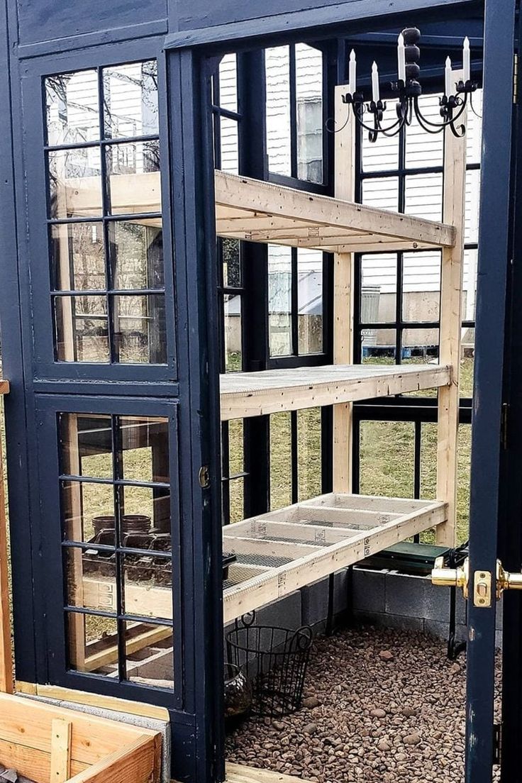 the inside of a building that is being built with wood and glass doors on it