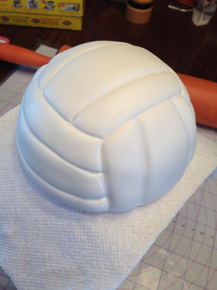 a plastic volleyball ball sitting on top of a white towel