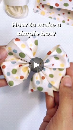 someone is tying a bow to a piece of fabric