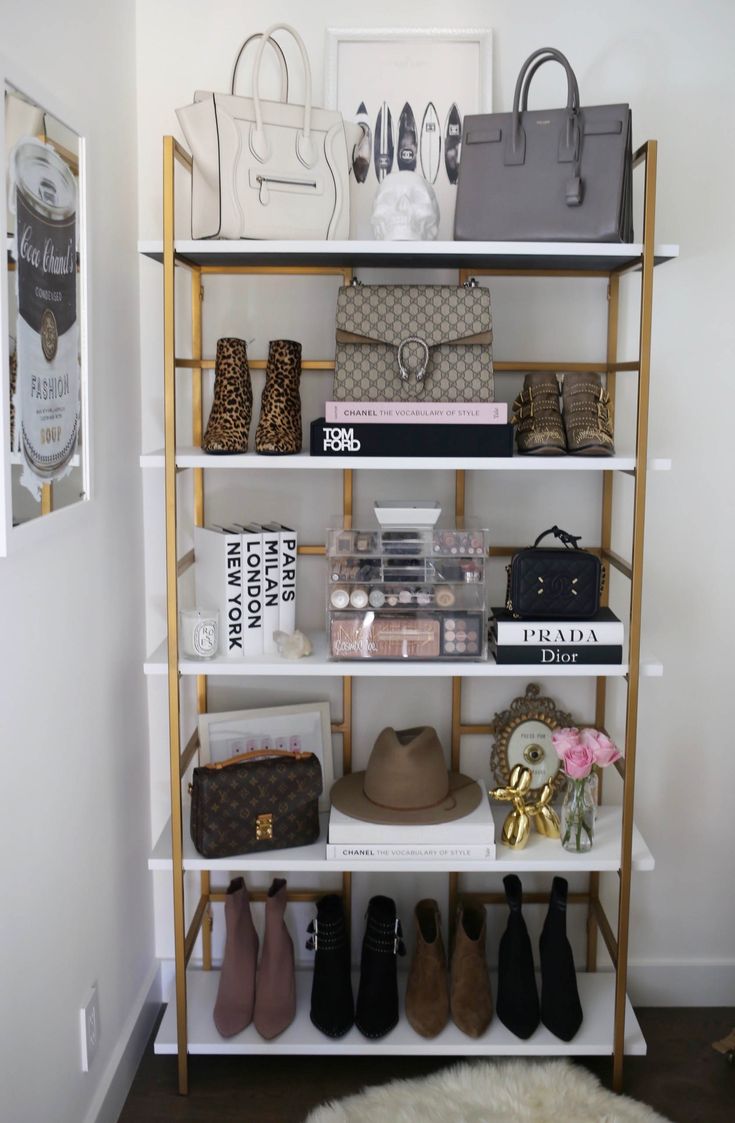 a white shelf filled with lots of shoes and bags