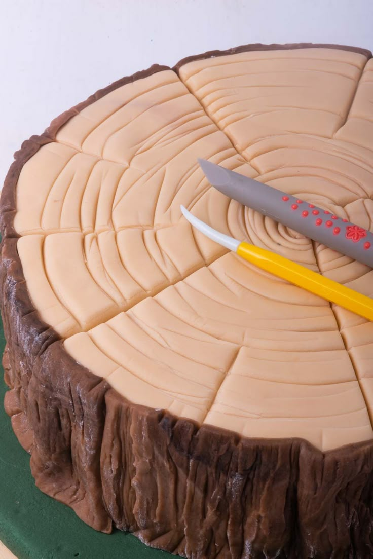 a knife is on top of a cake that looks like it has been carved into a tree stump