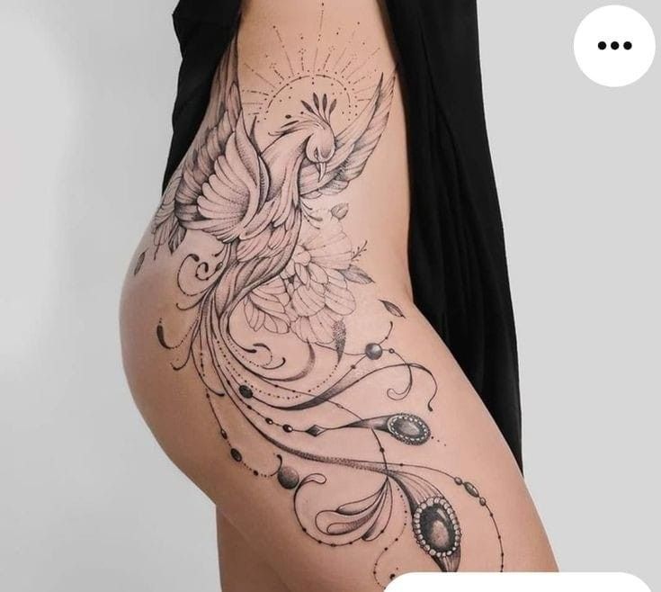 a woman's thigh with a bird tattoo on it