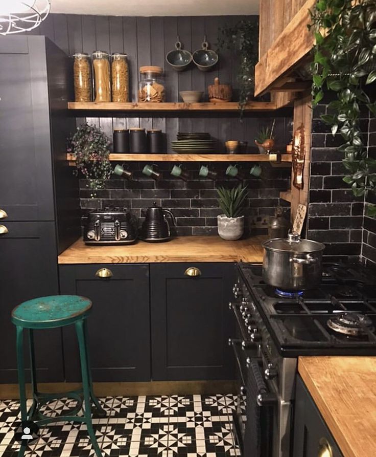 a kitchen with black and white tile flooring and wooden shelves filled with potted plants