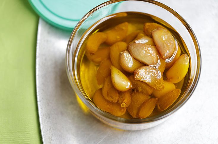 a glass jar filled with food sitting on top of a green and white table cloth