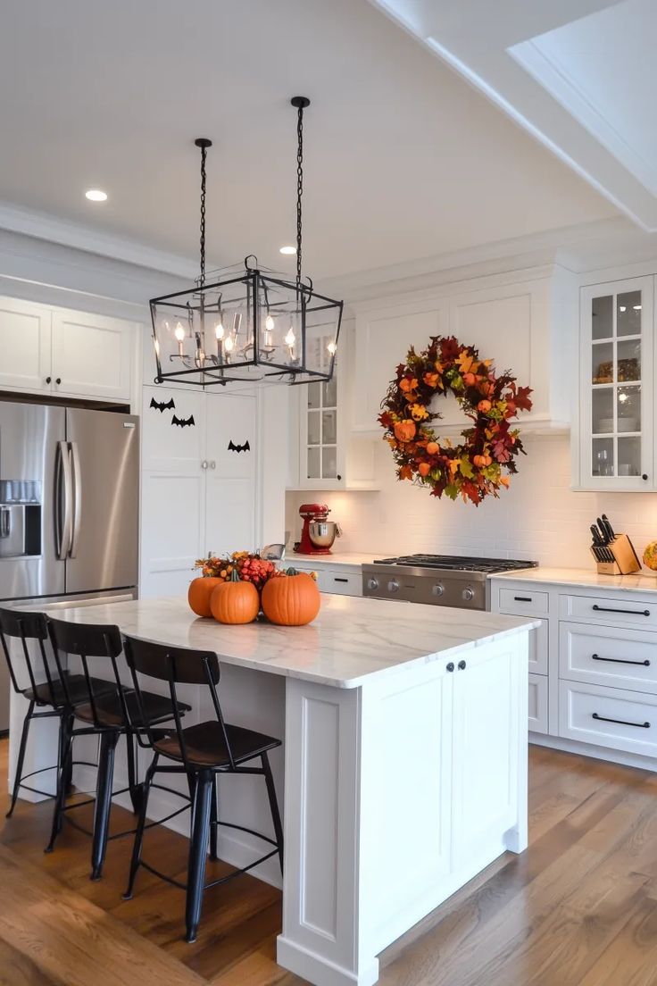 a kitchen with white cabinets and an island in the center surrounded by black bar stools