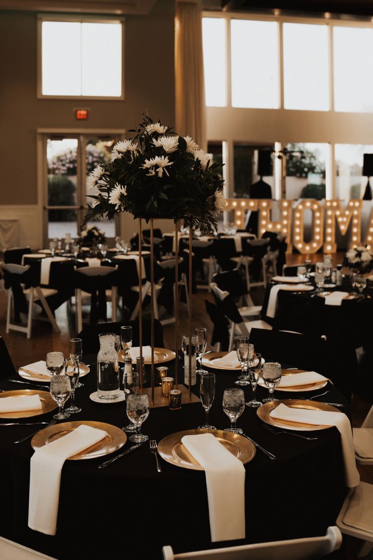 the tables are set with black and white linens