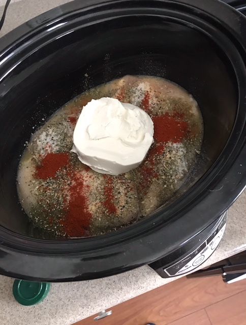 a crock pot filled with something white and red