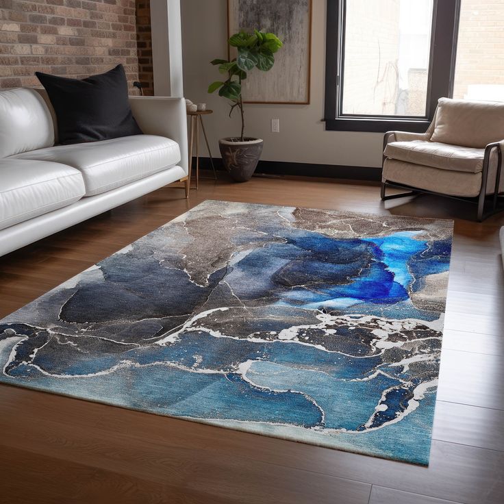 a living room with white couches and a blue rug on top of the floor