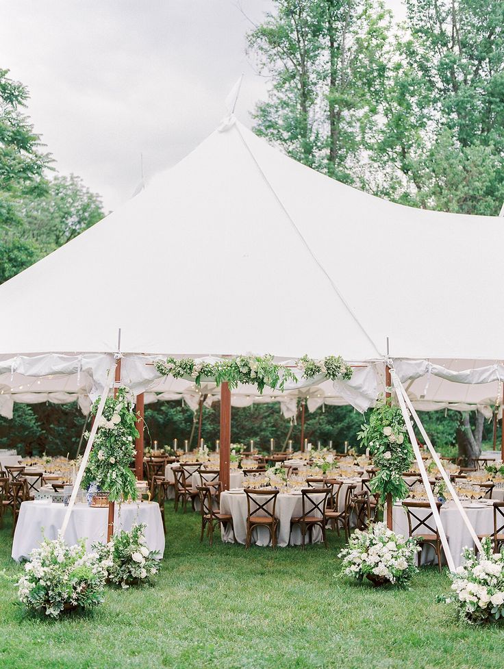 an outdoor tent with tables and chairs set up