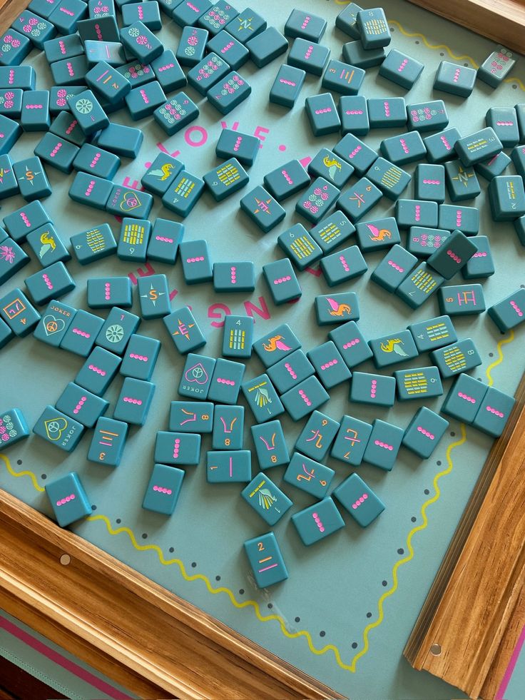 there are many blue and pink typewriters on the table with numbers in them