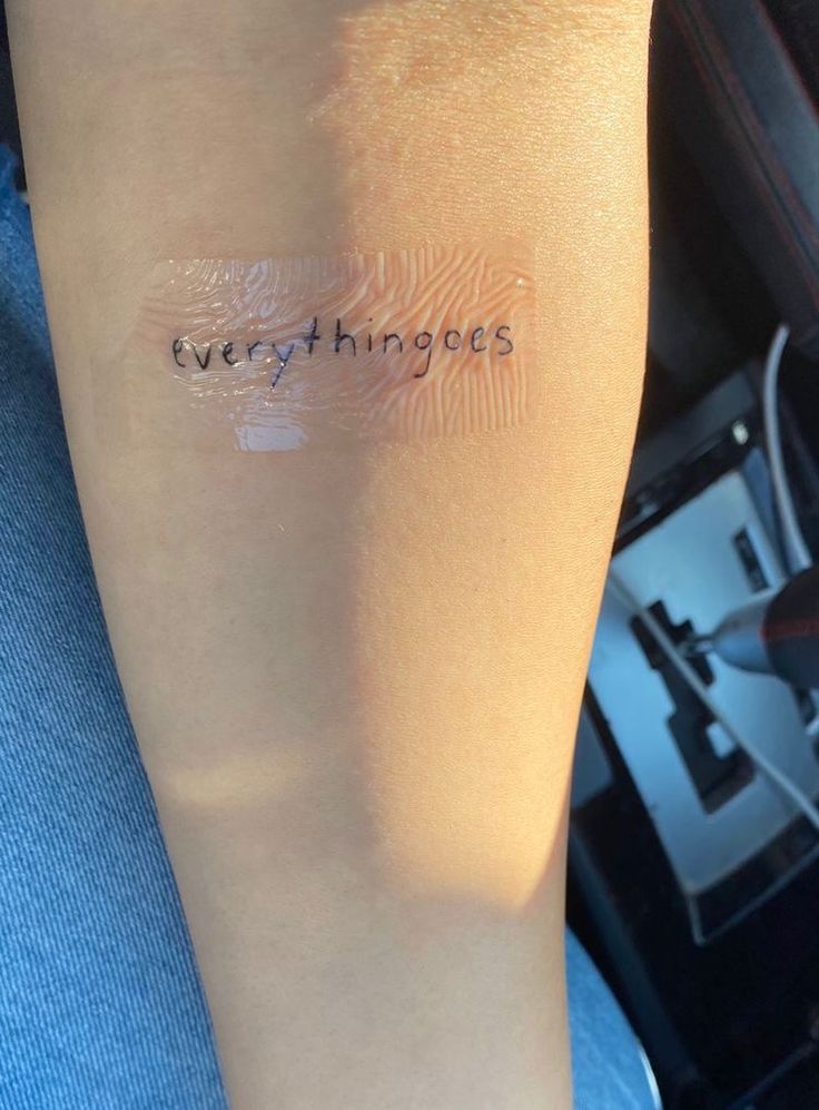 a person's arm with the words everything goes on it