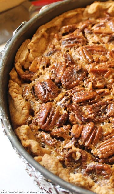 a pie with pecans in it sitting on a table