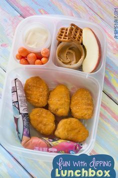 lunch box with chicken nuggets, carrots, apples and yogurt