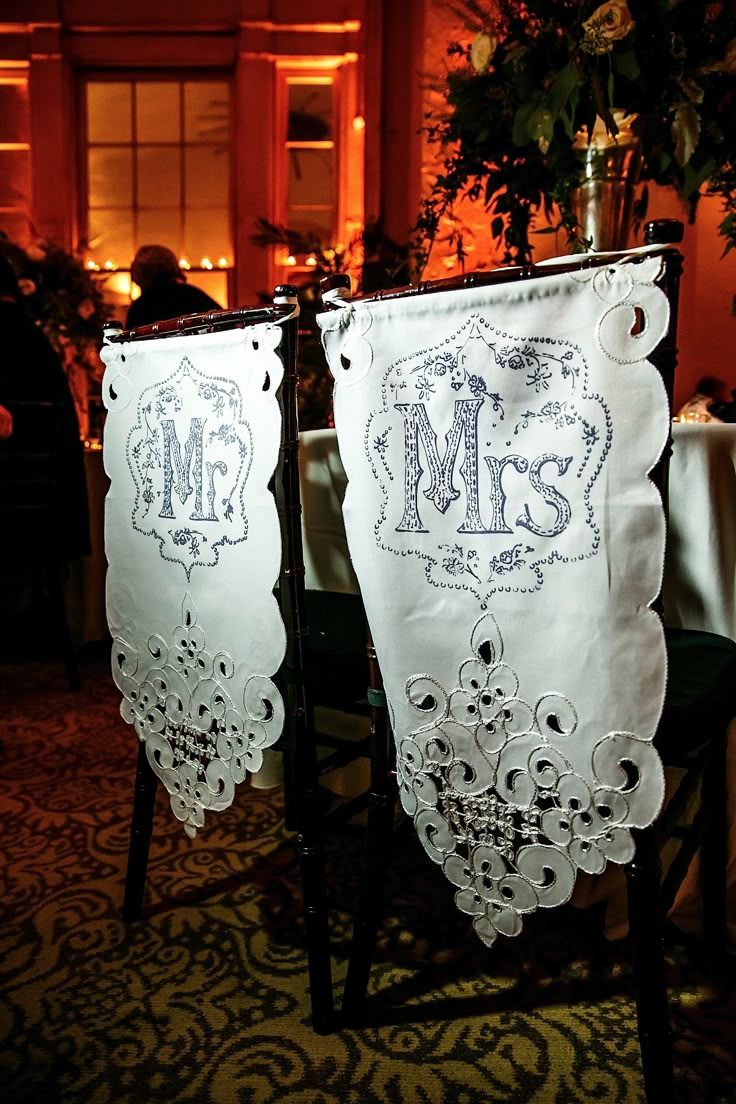 two white wedding decorations hanging from the ceiling