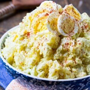 a blue and white bowl filled with mashed potatoes