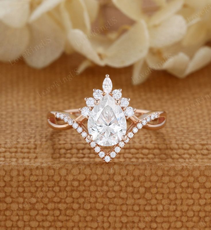 an engagement ring with a pear shaped diamond in the center